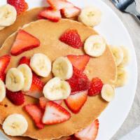 Banana Nut Pancakes · Topped with banana slices, powdered sugar and whipped cream.