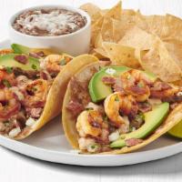  Grilled Shrimp Tacos Combo · Pan-seared shrimp served on corn tortillas with toasted cheese, all natural bacon, Hass avoc...