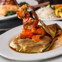 Salmon Vallarta · Salmon wrapped in banana leaves all baked with peppers, marinara sauce, & green olives. Serv...