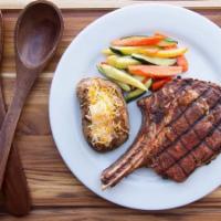 Rib Eye Steak · Rib eye steak bone-in cooked in port wine, served with steamed vegetables and spicy chipotle...