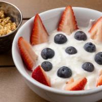 Greek Yogurt · Greek yogurt topped with berries, granola, and honey.