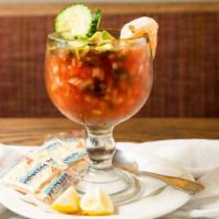 Coctel De Camaron · Large shrimp prepared in a Mexican style cocktail sauce, garnished with lemon and saltines.
