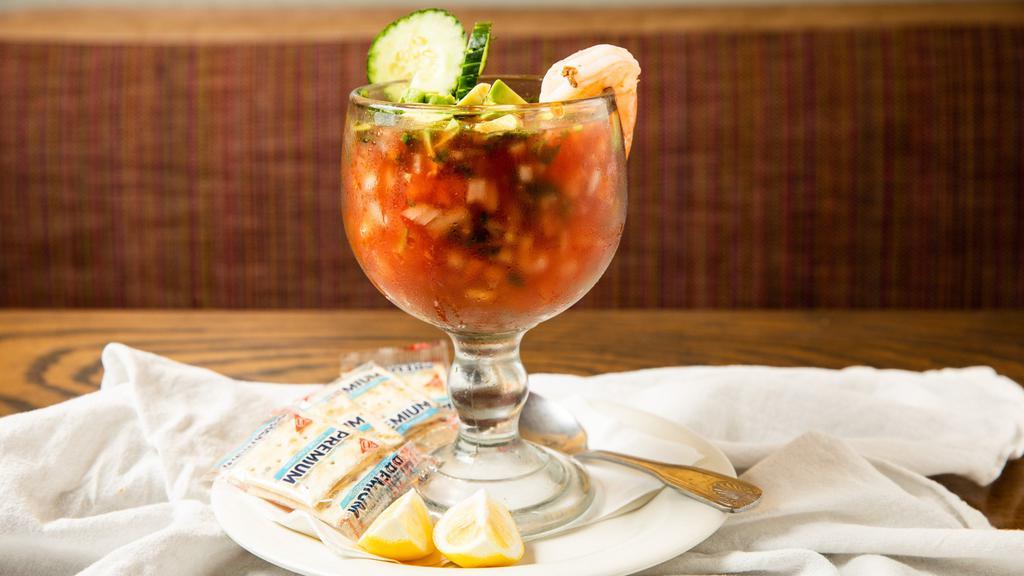 Coctel De Camaron · Large shrimp prepared in a Mexican style cocktail sauce, garnished with lemon and saltines.