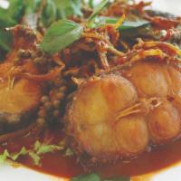 Spicy Catfish · Deep-fried slices of catfish cooked with red curry paste, chili, basil, pepper, and Thai her...