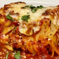 Lasagna · Homemade lasagna is baked with noodles, meats, cheese and sauce. Served with homemade bread.