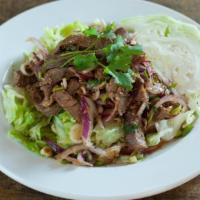 Neur Namtok · Grilled sliced steak, parched rice, shallot, lemongrass, onion, and cilantro in chili lime j...