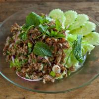 Larb Bpet · Minced roasted duck, parched rice, cilantro, shallot, and onion in chili lime juice.