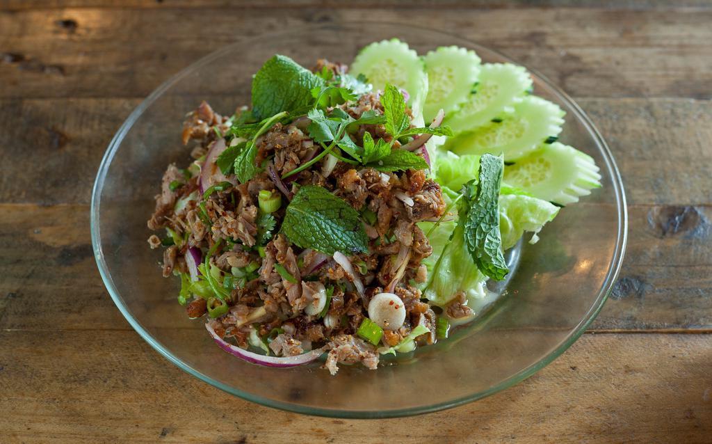 Larb Bpet · Minced roasted duck, parched rice, cilantro, shallot, and onion in chili lime juice.