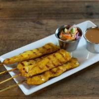 Gai Satay · Grilled marinated chicken skewer. Served with cucumber salad and peanut sauce.