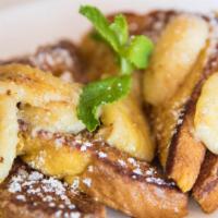 Cinnamon Banana French Toast · Thick slices of egg bread dipped in batter, grilled to perfection, topped with sauteed fresh...