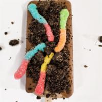 Dirt Pop · Cookies n cream pop + milk chocolate drizzle + gummy worms topped w/ Oreo crumbs