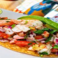 Tostada De Camarón · Shrimp ceviche cured in lime juice, topped with red onion, cilantro, avocado, tomatoes.