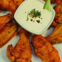 Buffalo Wings · Delicious buffalo wings, double marinated, baked to perfection, served with our home made ra...