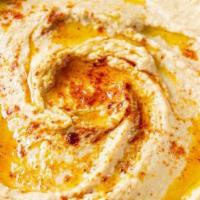 Hummus · Blended spread of garbanzo beans made with sesame paste, garlic and lemon juice, topped with...