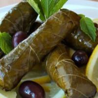 Grape Leaves · 4 pcs. Rice, tomatoes, parsley and spices wrapped in grape leaves.
