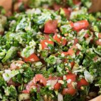 Tabouleh · Delicately chopped parsley salad, mixed with tomatoes, onions, olive oil and lemon juice.