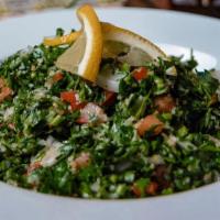 Tabouleh · Chopped fresh parsley, mixed with Bulgur, Tomatoes, Onions, Fresh Lemon Juice, and Virgin Ol...