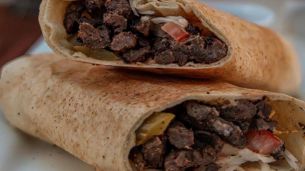Beef Shawarma Wrap · Special made beef wrapped with Parsley, Red Onions, Tomatoes, Pickled Turnips, and Tahini in toasted Bread.