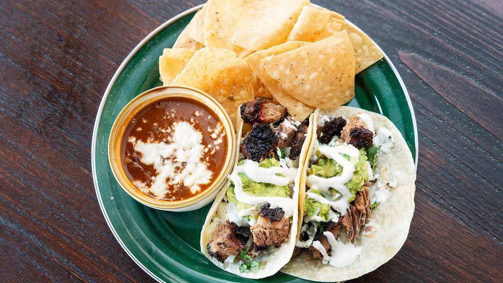 Taco Plate · Taco Plate - Two flour tortillas stuffed with smoked pork or chicken, onion cilantro, jack cheese. Served with chips, salsa fresca and charro beans.