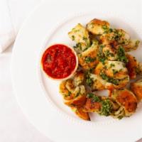 Garlic Knots · Housemade garlic knots with parsley and fresh chopped garlic tossed in our signature chili o...