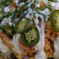 Pollo Nachos (Chips) · Freshly fried chips topped with our smoky refried beans, thick queso, crema, tomatoes, onion...