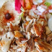 Chicken Shawerma Plate · Sliced marinated chicken served with hummus, salad, rice, garlic, grilled tomato and 2 pita ...