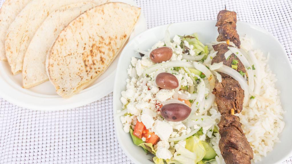 Beef Kabob Plate · Flame broiled of filet beef served with hummus, salad, rice, parsley, onion, grilled tomato and 2 pita bread.