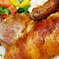 Half Chicken Plate · Half a golden roasted chicken. Served with hummus, salad, rice, garlic, and pita bread.