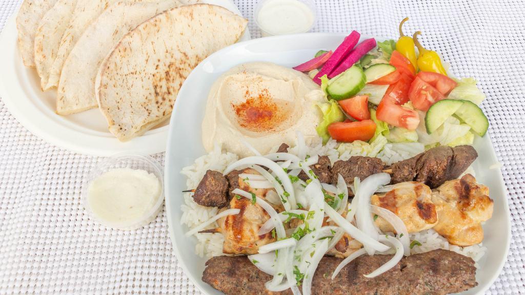 Combo Kabob Plate · Skewer of beef kabob, chicken kabob, and kafta kabob. Served with hummus, salad, rice, parsley, onion, garlic sauce, grilled tomato and 2 pita bread.