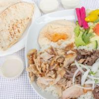 Combo Shawerma Plate · Slices marinated chicken and meat. Served with hummus, salad, rice, tahini & garlic sauce, g...