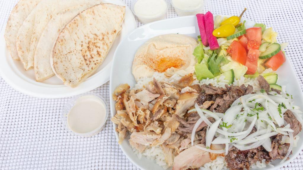 Combo Shawerma Plate · Slices marinated chicken and meat. Served with hummus, salad, rice, tahini & garlic sauce, grilled tomato and 2 pita bread.