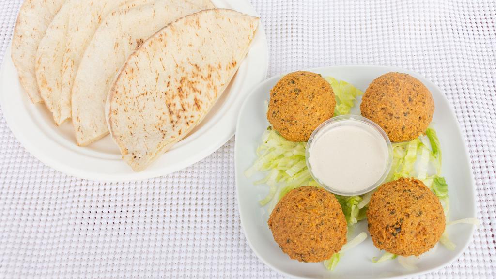 Falafel Plate · A golden fried mixture of garbanzo beans, parsley, and spices. Served with hummus, salad, tahini sauce, and 2 pita bread.