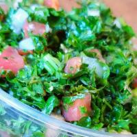 Tabbouleh · Finely chopped parsley, tomatoes, onions, cracked wheat, lemon juice, and olive oil.