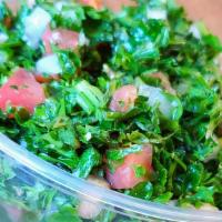 Tabbouleh · Finely chopped parsley, tomatoes, onions, cracked wheat, lemon juice, and olive oil.