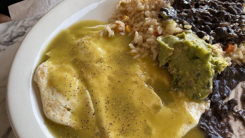 Chilaquiles · Eggs scrambled with corn tortilla chips, salsa verde sauce topped with guacamole, sour cream, pico de gallo served with black beans on the side.