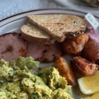 Green Eggs & Ham · Thick sliced Canadian bacon accompanied by farm fresh eggs, scrambled with a garlic basil pe...