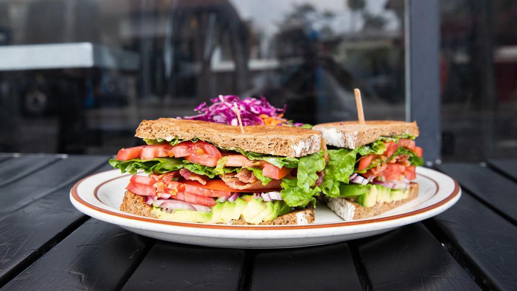 L.A.T · Crispy bacon or turkey bacon, lettuce, avocado, tomato, and red onions with mayonnaise on toasted multi-grain. Served with your choice of potato salad, green salad, red slaw, and french fries.