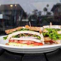 New Times Club · Turkey breast, bacon or turkey bacon, lettuce, avocado, red onions, and herb mayonnaise on t...