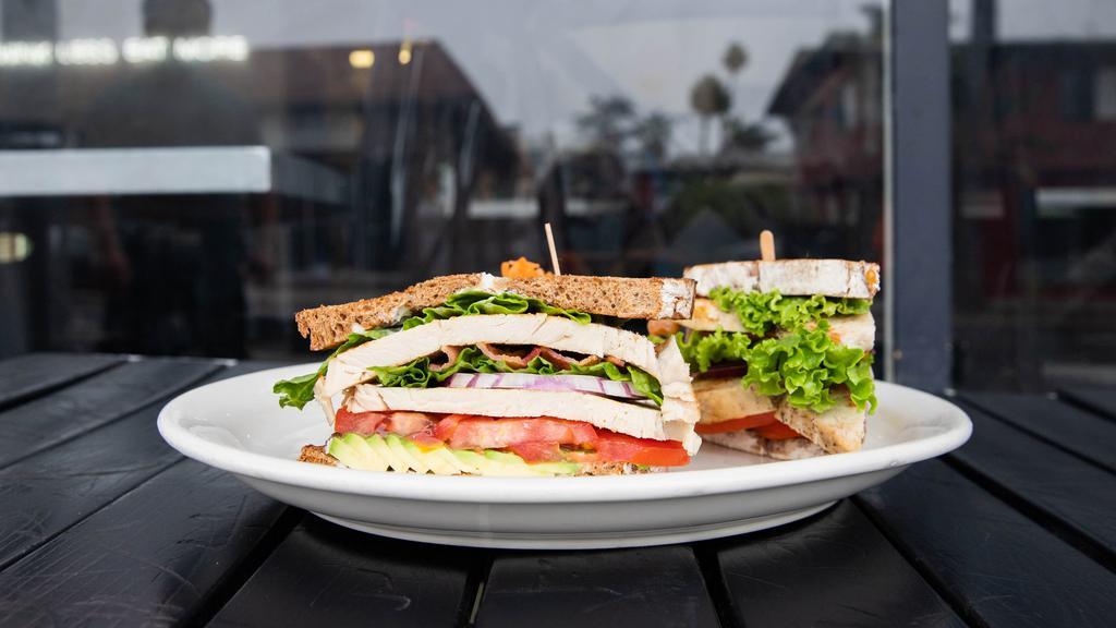 New Times Club · Turkey breast, bacon or turkey bacon, lettuce, avocado, red onions, and herb mayonnaise on toasted multi-grain. Served with your choice of potato salad, green salad, red slaw., and french fries.
