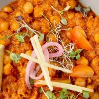 Amritsari Chole · Chickpeas cooked with cumin seeds, coriander, ginger, garlic, tomatoes and onions. Garnished...