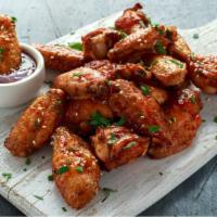 Traditional Sweet Chili Gochujang Wings · Delicious traditional crispy wings tossed with sweet chili sauce, served with carrots and ce...