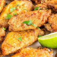 Lemon Pepper Wings · Golden, fried wings. Crispy on the outside, juicy on the side, smothered in tangy, pepper Le...