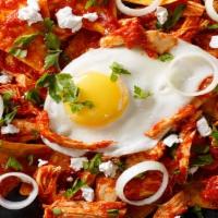 Chilaquiles With Eggs · Chilaquiles with Eggs: fried corn tortilla chips, then sautéed with green or red salsa and t...