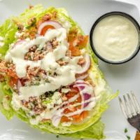 Wedge · Iceberg lettuce wedge, diced fresh tomato, bacon, red onion, bleu cheese crumbles, served wi...