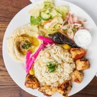 Chicken Kebab Plate · Rice, Hummus, Carrots, Pita bread, and Pickled Turnips.