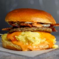 Big Breakfast Brioche Sandwich · 2 fresh cracked cage-free scrambled eggs, melted Cheddar cheese, bacon, breakfast sausage, g...