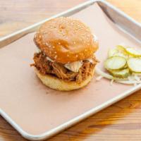 Pulled Pork Sandwich · Brioche bun, classic coleslaw, and Carolina-style BBQ sauce. Comes with two sides.