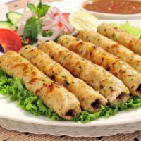 Chicken Seekh Kabob · Fresh chicken minced with special herbs. Served with a side of white rice and house salad.