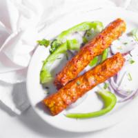 Chicken Seekh Kebab · Ground chicken marinated with freshly ground spices, rolled on a skewer and cooked in tandoor.