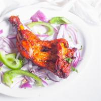 Tandoori Chicken · Juicy spring chicken marinated in yogurt and freshly ground spices and cooked in tandoor.